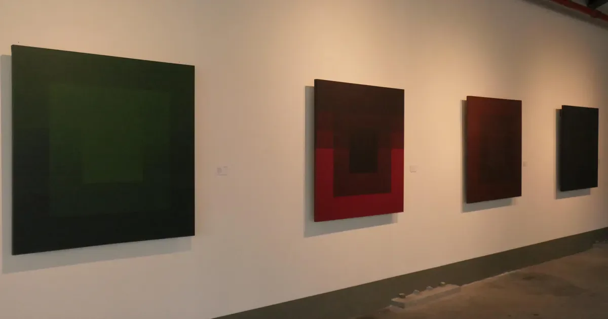 Leon Tovar Gallery interior with series of color-field artworks hung on white wall—large green canvas and three dark red and brown abstract paintings.