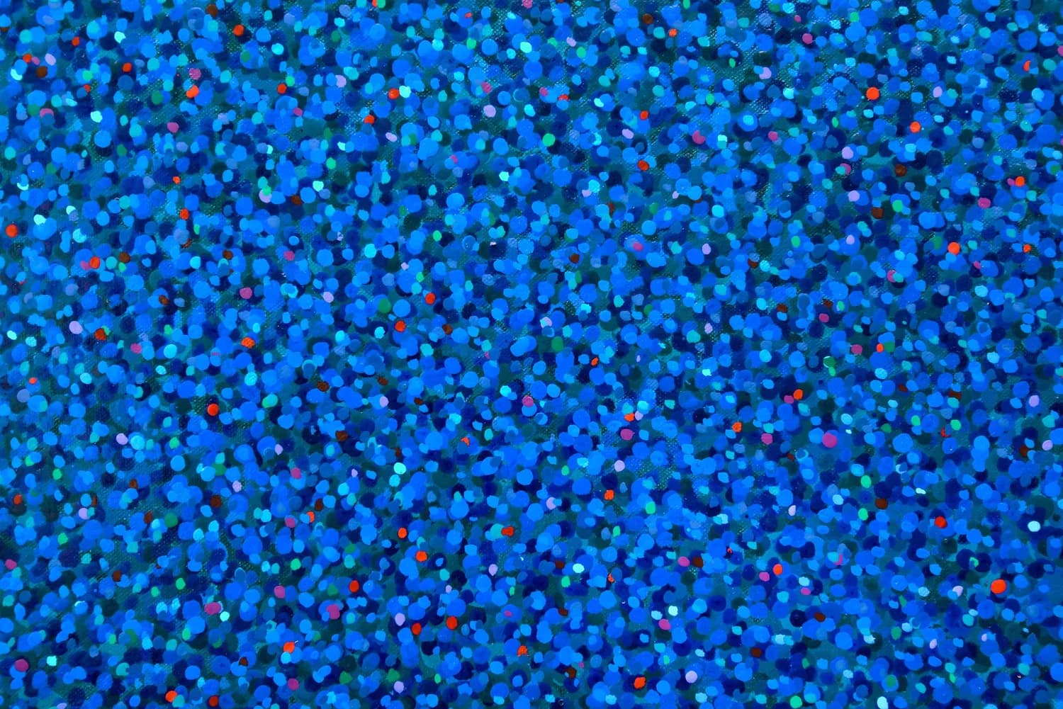 Abstract composition of densely packed blue, cyan, and red glitter or sequin-like particles covering the entire surface.