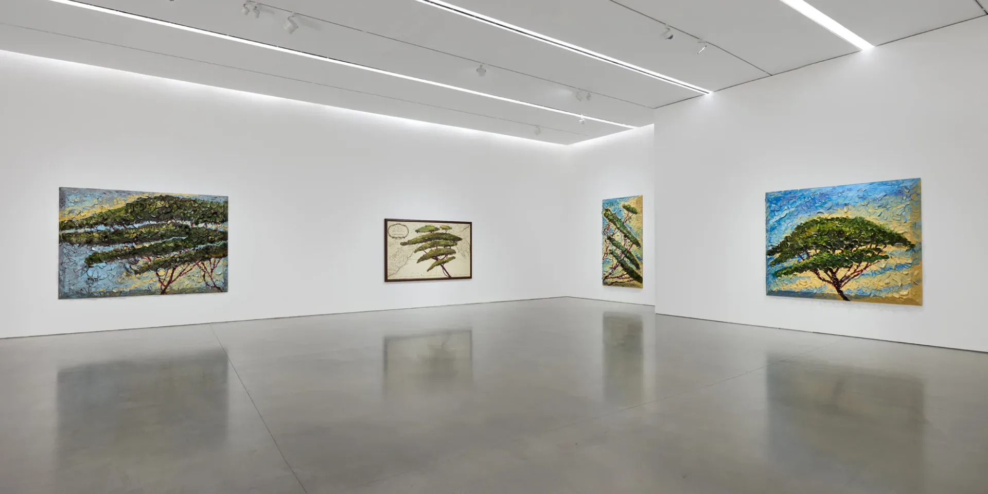 Minimalist gallery space with four landscape paintings of trees displayed on white walls under recessed ceiling lights, polished concrete floor.