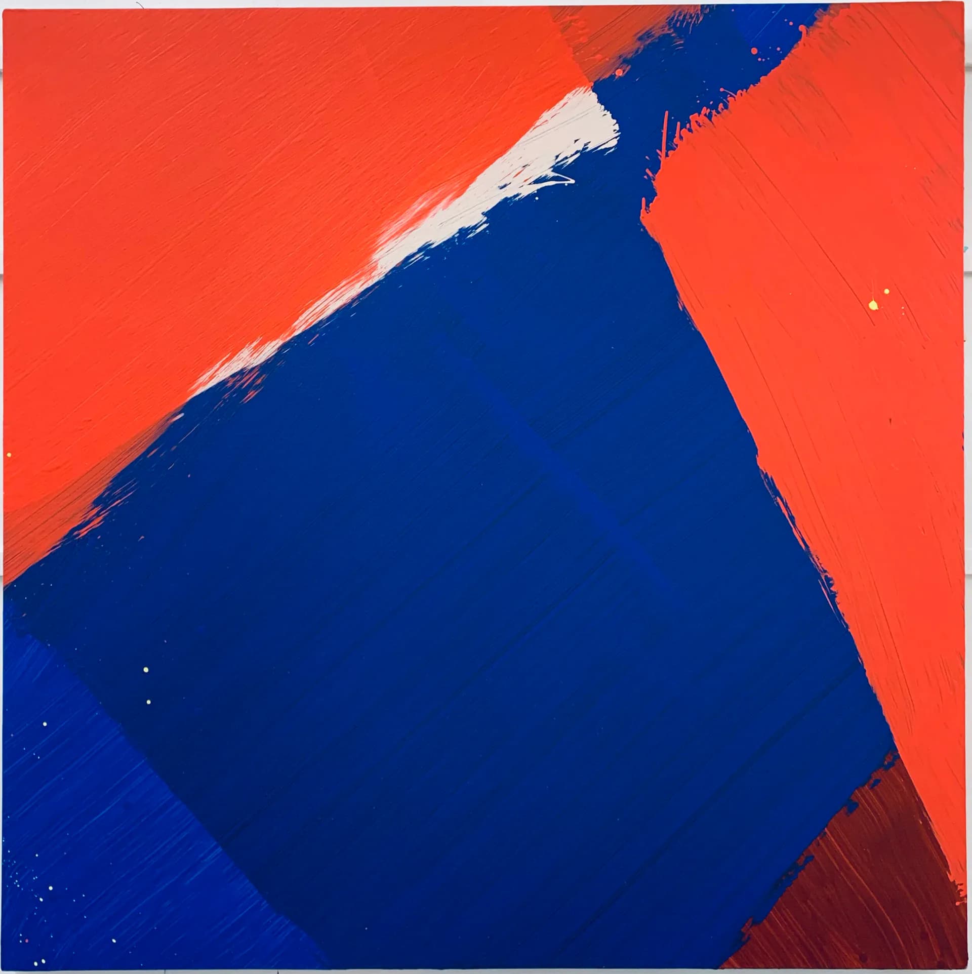 Abstract geometric painting with bold contrasts of deep blue, bright red, and white diagonal shapes.