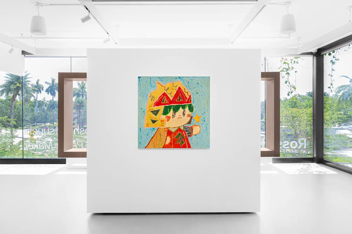 Bright modern gallery space with floor-to-ceiling windows, pendant lighting, and a single colorful figure painting displayed on a white central pedestal.
