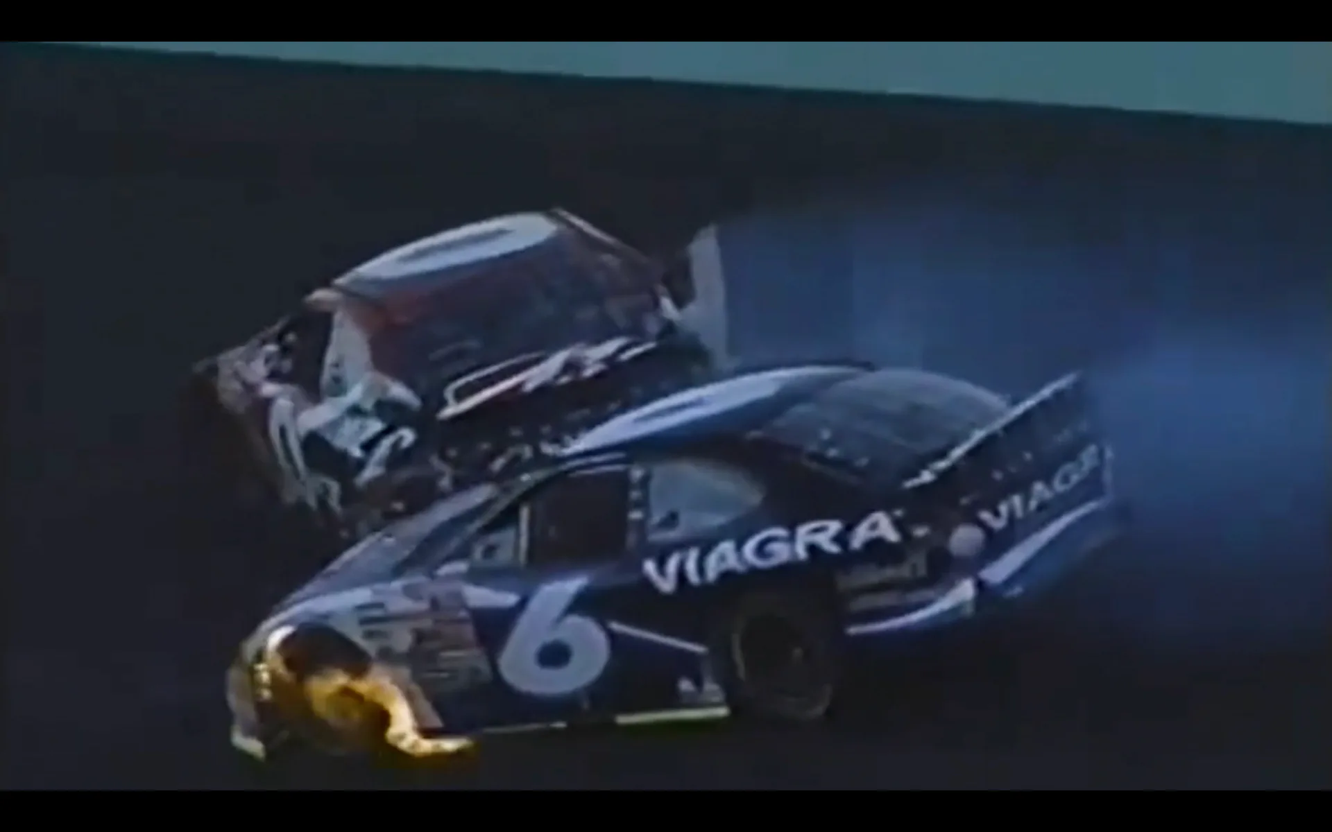 Two race cars colliding in dramatic motion with blue and purple lighting and Viagra branding visible.