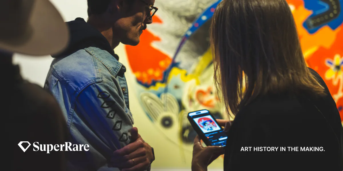 Two people in a gallery space viewing colorful abstract artwork, with SuperRare logo and 'ART HISTORY IN THE MAKING' tagline.