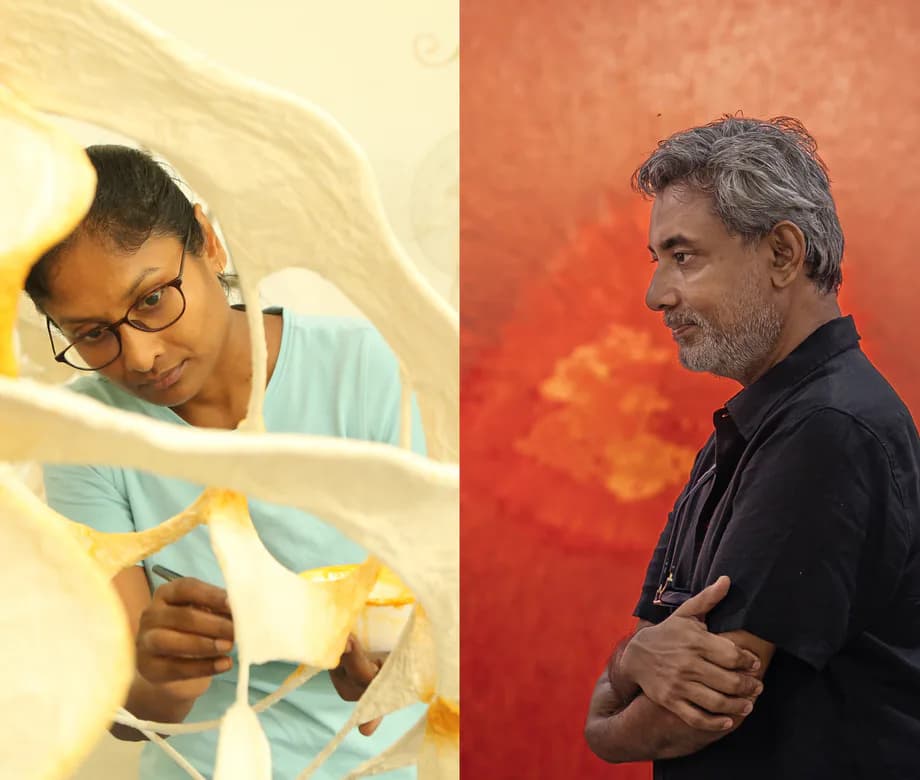 Split-screen portrait of two men: left figure in light blue shirt with glasses examining white sculptural form; right figure in black shirt against warm orange-red abstract background.