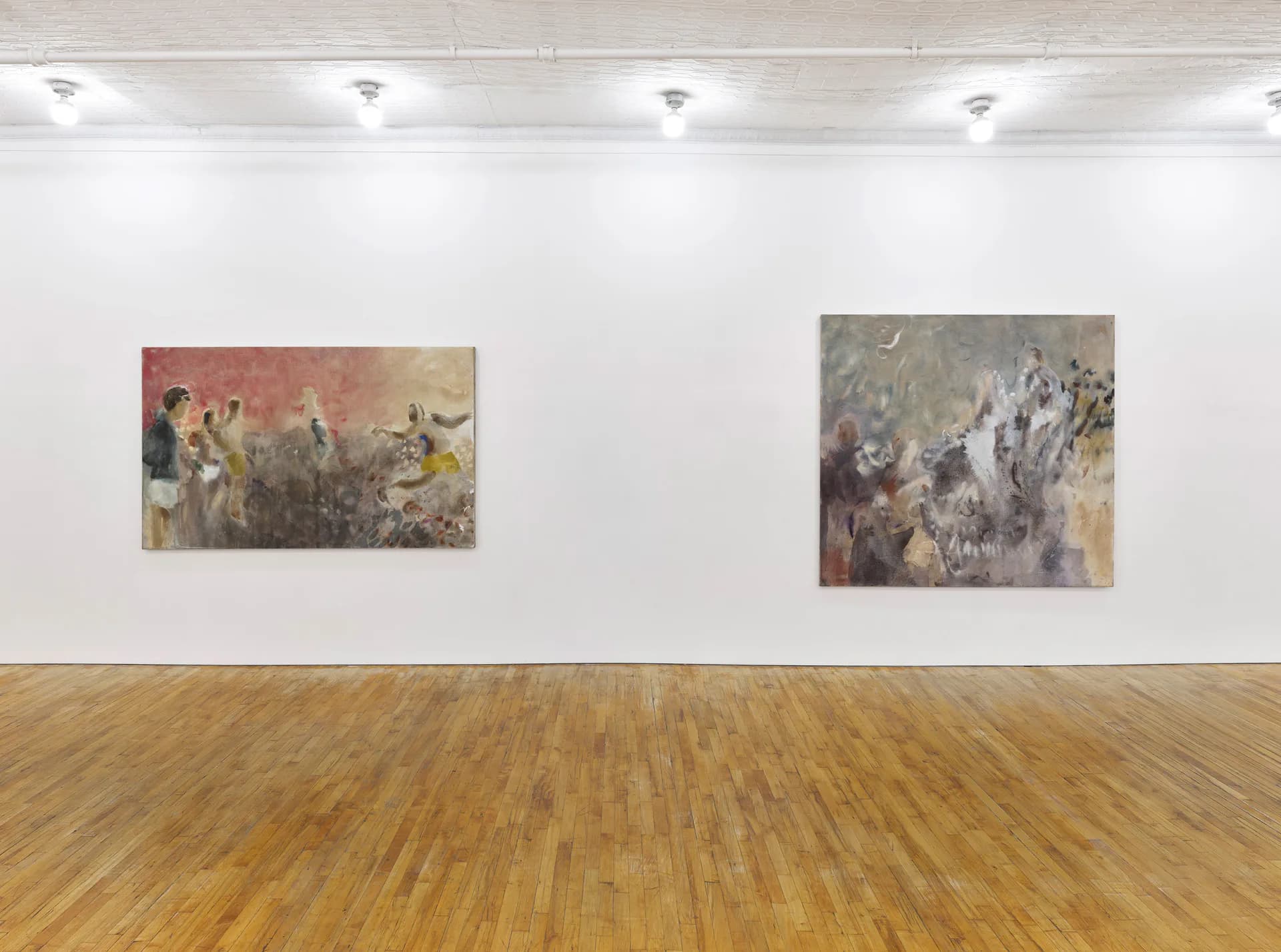Gallery wall with recessed lighting displaying two framed mixed-media artworks by Tara Downs with warm and cool tonal abstractions.