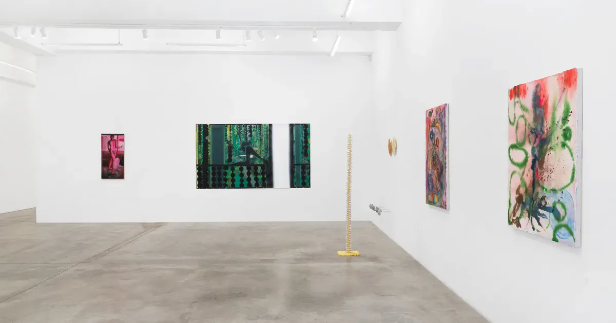 Gallery interior at Tina Kim Gallery with white walls displaying colorful abstract paintings of varying sizes on the left and right walls, polished concrete floor.