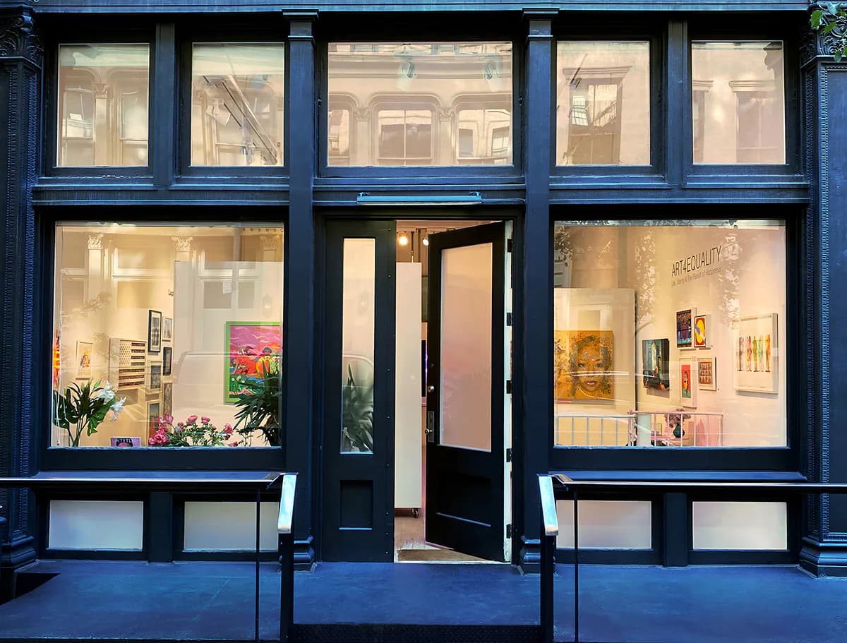 Storefront of Untitled Space gallery in Tribeca with dark blue framing, large display windows showing artwork and plants, and a black entrance door.