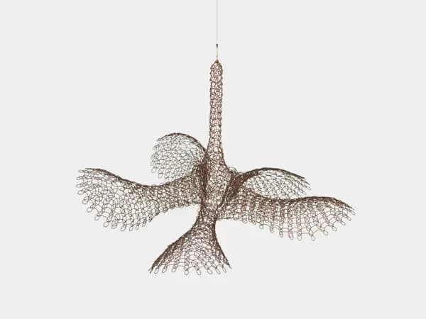 Hanging sculptural mobile with intricate wire mesh forms resembling organic shapes or leaves suspended from central stem.